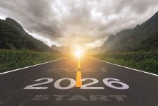 2026, the new year 2026 or the beginning of the concept of the word 2026, written on a road in the middle of a paved road with a sunset mountain backdrop. Planning ideas and challenges.