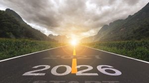 2026, the new year 2026 or the beginning of the concept of the word 2026, written on a road in the middle of a paved road with a sunset mountain backdrop. Planning ideas and challenges.